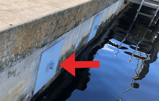 Helical tie-back anchor plate installed through a seawall face