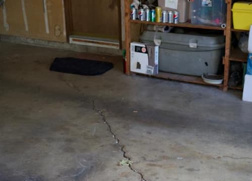 Settlement crack running across a residential garage slab